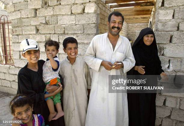 Misal Hamed al-Kubaishat , the brother of Lateef Hamed al Kubaishat, a reputed gangster and bombmaker nicknamed "Scarface" by US soldiers poses for a...