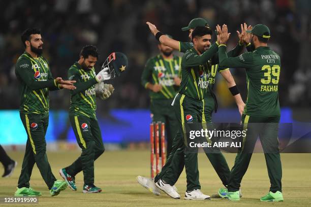 Pakistan's cricketers celebrate after the dismissal of New Zealand's Will Young during the third Twenty20 international cricket match between...