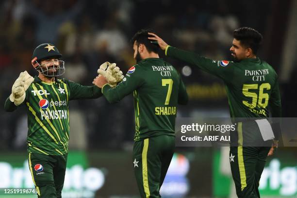 Pakistan's Shadab Khan celebrates with teammates after taking the wicket of New Zealand's Will Young during the third Twenty20 international cricket...