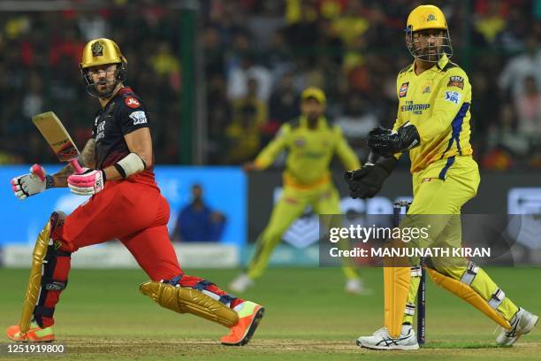Royal Challengers Bangalore's Faf du Plessis and Chennai Super Kings' Mahendra Singh Dhoni gesture during the Indian Premier League Twenty20 cricket...