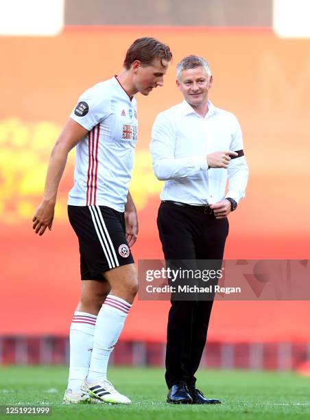 Ole Gunnar Solskjaer, Manager of Manchester United speaks to Sander Berge of Sheffield United after the Premier League match between Manchester...