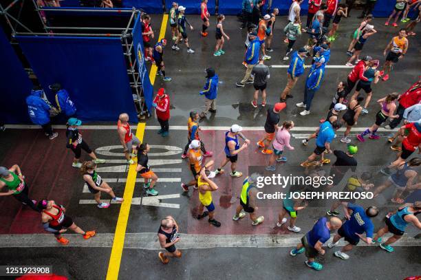 Runners move away from the finish line during the 127th Boston Marathon in Boston, Massachusetts, on April 17, 2023. - In wet and windy conditions,...