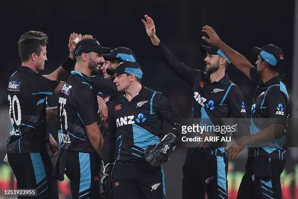 New Zealand's cricketers celebrate after the dismissal of Pakistan's captain Babar Azam during the third Twenty20 international cricket match between...