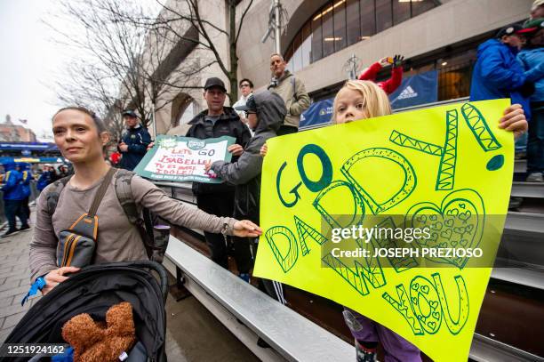 Spectators watch and cheer on runners during the 127th Boston Marathon in Boston, Massachusetts on April 17, 2023. - In wet and windy conditions,...