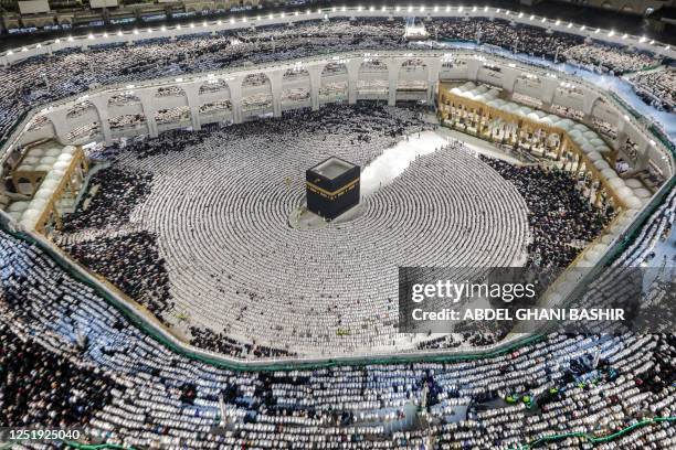 Muslim worshippers pray around the Kaaba, Islam's holiest shrine, at the Grand Mosque in the holy city of Mecca on April 17 on the night of 27...