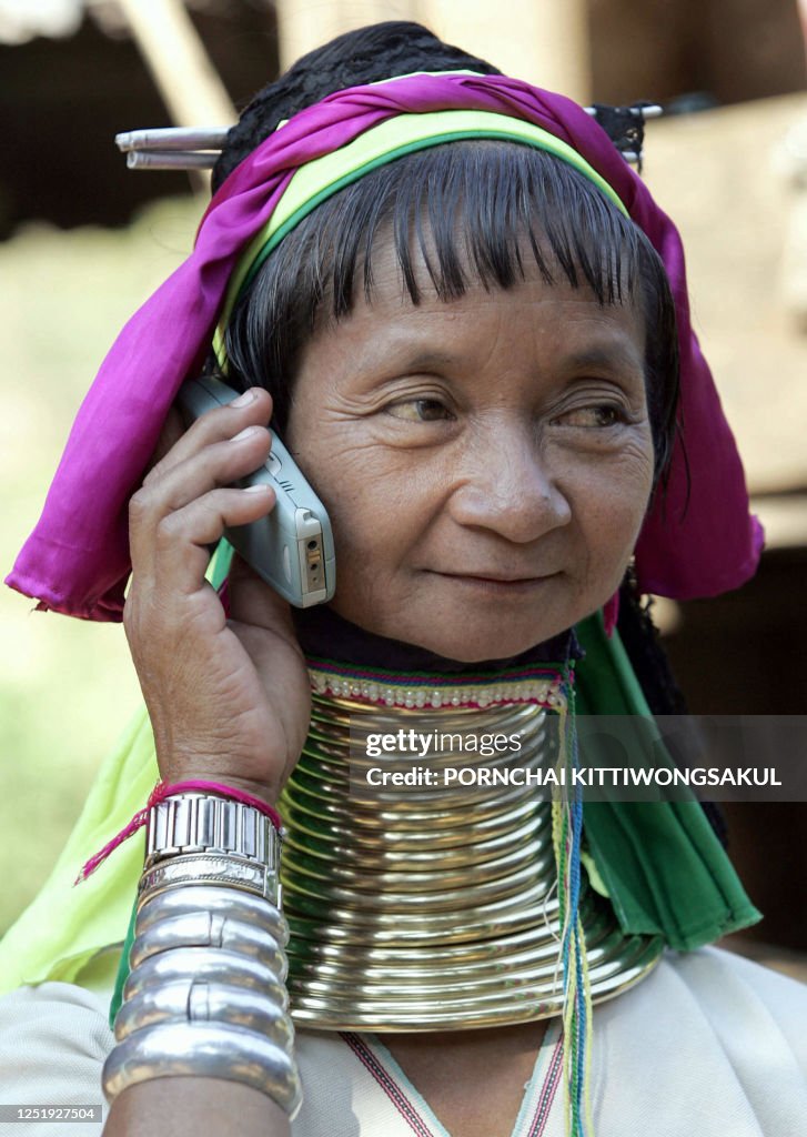 Neck Rigns A Long Neck Karen woman wearing multiple brass rings around her neck ...
