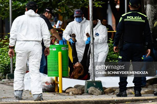 Graphic content / Members of the Technical Investigation Team remove the body of a woman killed by an explosion in Cucuta, on Colombia's border with...