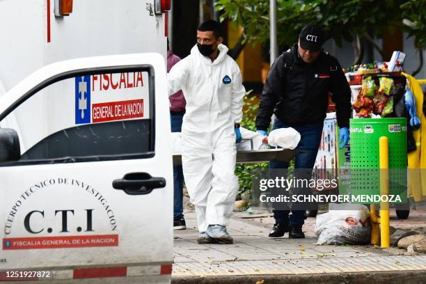 Members of the Technical Investigation Team remove the body of a woman killed by an explosion in Cucuta, on Colombia's border with Venezuela, on...