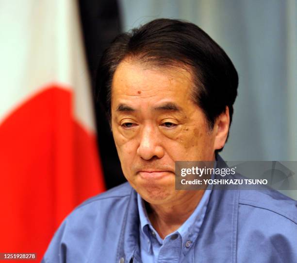 Japanese Prime Minister Naoto Kan bites his lip as he delivers a message to the Japanese people at his official residence in Tokyo on March 25, 2011....