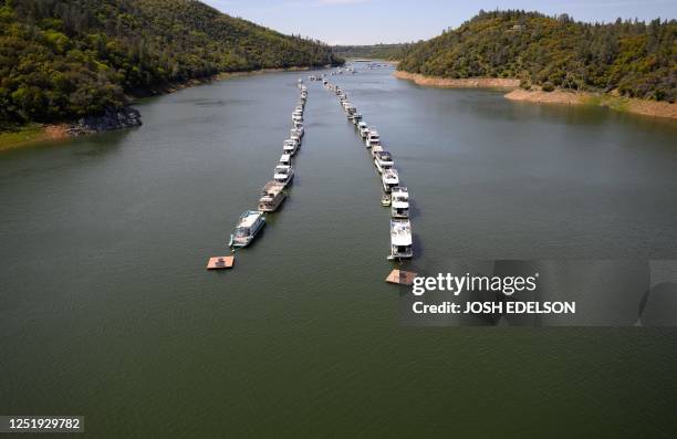 Boats are parked on a filled Lake Oroville in Oroville, California, on April 16, 2023. - A very wet winter has left California's reservoirs looking...