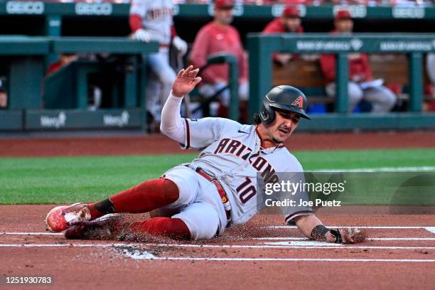Josh Rojas of the Arizona Diamondbacks slides into home plate for a run against the St. Louis Cardinals in the first inning at Busch Stadium on April...