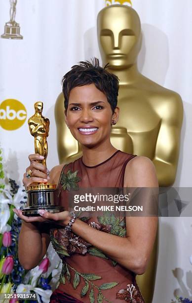 Actress Halle Berry holds her Oscar after winning the award for Best Actress in a Leading Role for her portrayal of Leticia Musgrove, a woman...