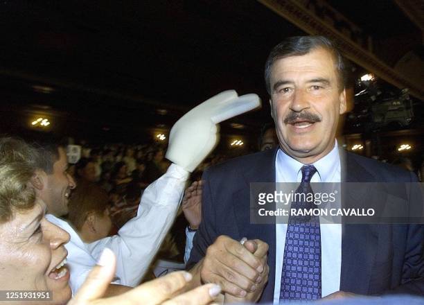 Vicente Fox, presidential canddiate for the Cambio Alliance is greeted by supporters at the national theater in Mexico City, 09 May 2000. Vicente...