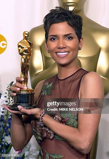 Actress Halle Berry holds her Oscar after winning the award for best actress in a leading role for her portrayal of Leticia Musgrove, a woman...