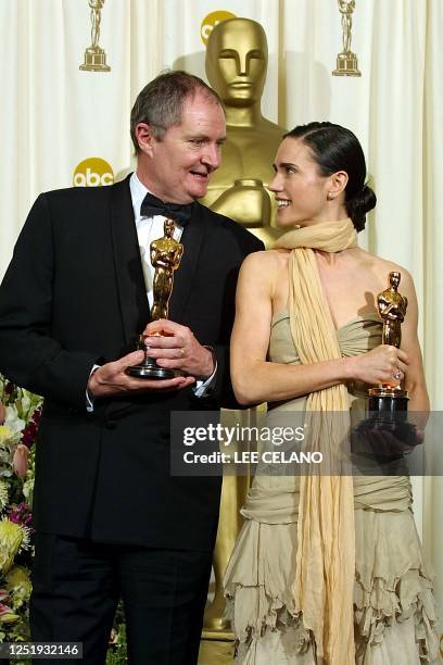 British actor Jim Broadbent and US actress Jennifer Connelly hold their Oscar statues after winning, respectively, the award for best supporting...