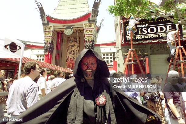 Mickie Lujan from North Hollywood dressed as Darth Maul, the evil Sith lord from "Star Wars Episode 1: The Phantom Menace," poses outside the Mann's...