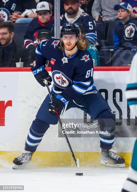 Kyle Connor of the Winnipeg Jets plays the puck during second period action against the San Jose Sharks at Canada Life Centre on April 10, 2023 in...