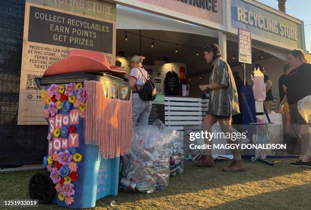 Attendees bring items to a recycling center on the grounds of the Coachella Valley Music and Arts Festival in Indio, California, April 16, 2023. -...