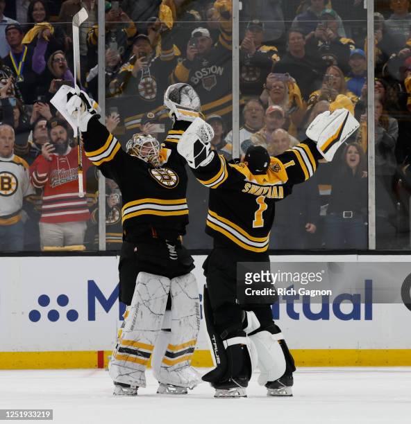 Linus Ullmark of the Boston Bruins and teammate Jeremy Swayman celebrate a win against the Florida Panthers after Game One of the First Round of the...