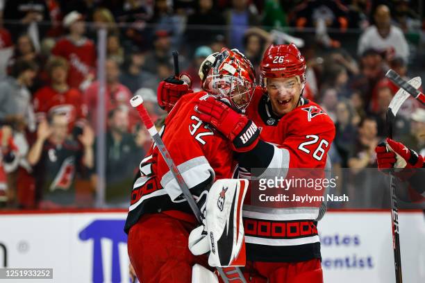 Antti Raanta of the Carolina Hurricanes and Paul Stastny celebrate their win against the New York Islanders after the third period of Eastern...