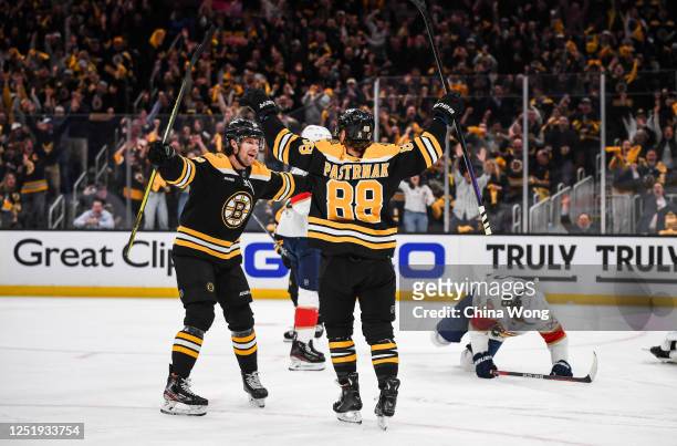 David Pastrnak of the Boston Bruins celebrates his first period goal with teammate Pavel Zacha against the Florida Panthers in Game One of the First...