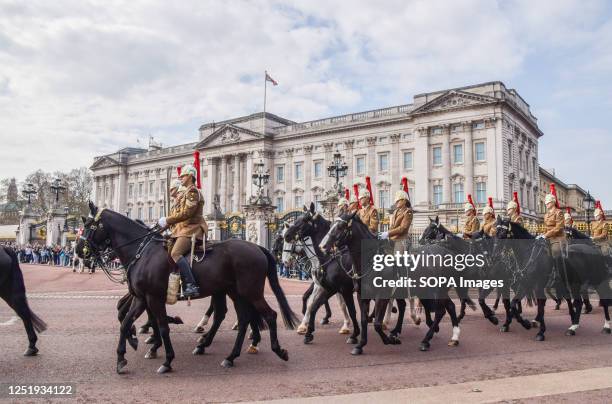 Members of the Household Cavalry Mounted Regiment pass by Buckingham Palace during rehearsals for the coronation of King Charles III and Queen...