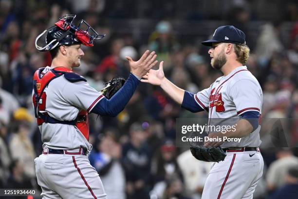 Minter of the Atlanta Braves, right, is congratulated by Sean Murphy after the Braves beat the San Diego Padres 2-0 in a baseball game April 17, 2023...