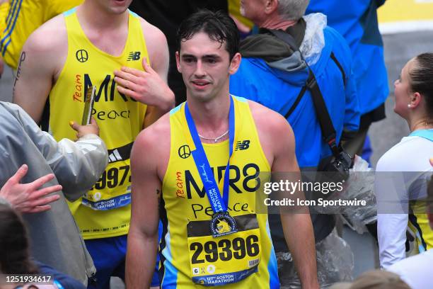 Henry Richard, captain of Team MR8, looks on after receiving his finisher's medal for the 127th Boston Marathon on April 17, 2023 on Boylston Street...