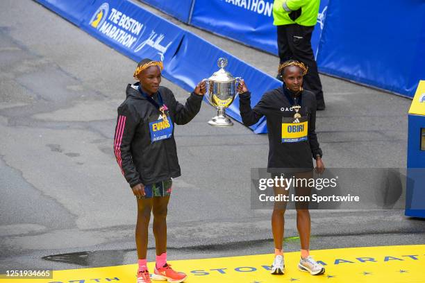 Evans Chebet of Kenya and Hellen Obiri of Kenya pose for photos after Chebet won the men's division and Obiri won the women's division of the 127th...