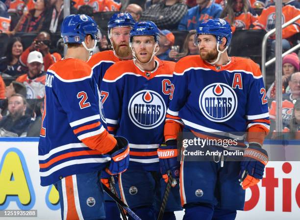 Evan Bouchard, Mattias Ekholm, Connor McDavid and Leon Draisaitl of the Edmonton Oilers discuss the play in Game One of the First Round of the 2023...