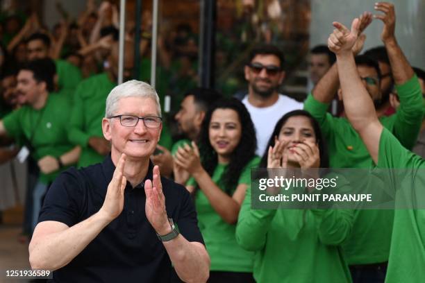 Chief Executive Officer of Apple Tim Cook claps during the opening of Apple's first retail store in India, in Mumbai on April 18, 2023. - Apple...