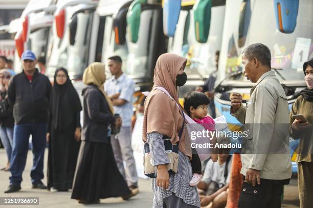 Passengers prepare to depart for their hometowns ahead of the Muslim Eid al-Fitr holiday at Pondok Cabe bus station in South Tangerang, Banten,...