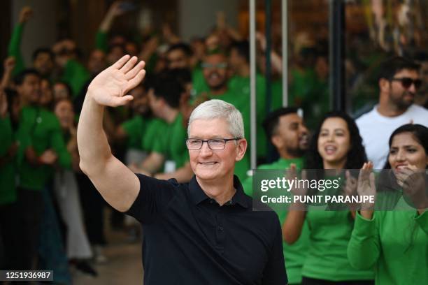 Chief Executive Officer of Apple Tim Cook waves during the opening of Apple's first retail store in India, in Mumbai on April 18, 2023. - Apple...