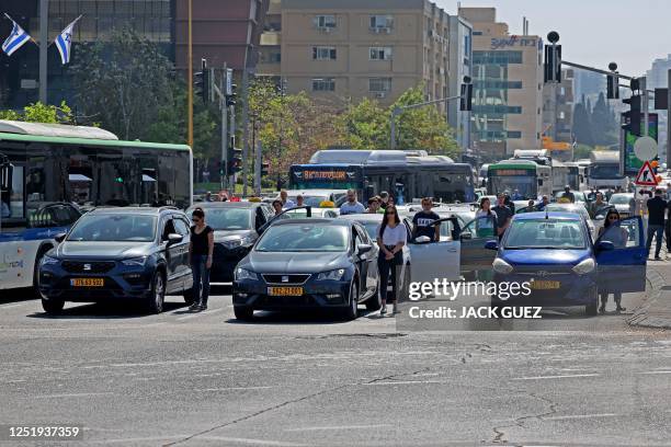 Drivers stand still in Tel Aviv on April 18, 2023 as sirens blare for two minutes marking Israel's annual Holocaust Remembrance Day in memory of the...