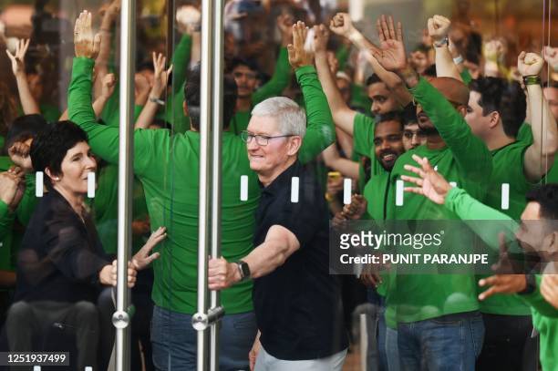 Chief Executive Officer of Apple Tim Cook and Apple's Senior Vice President of Retail and People Deirdre O'Brien prepare to open the doors of Apple's...