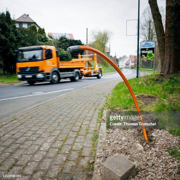 Symbolic photo on the subject of fiber optic expansion. A newly laid fiber optic cable is buried in the ground next to a road on April 12, 2023 in...