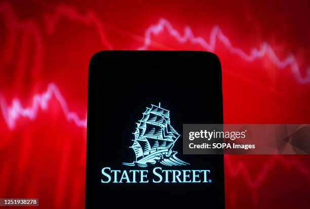 In this photo illustration, State Street Corporation logo is seen on a smartphone screen.