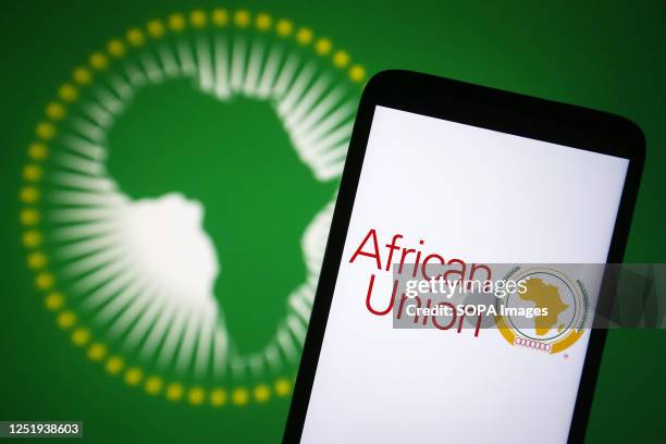 In this photo illustration, African Union logo is seen on a smartphone and African Union flag on a pc screen.