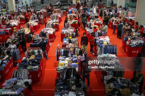 Visitors are selecting clothes being sold by outlet at a Mall in Malang City, East Java, Indonesia, On April 18, 2023. Wearing new clothes has become...