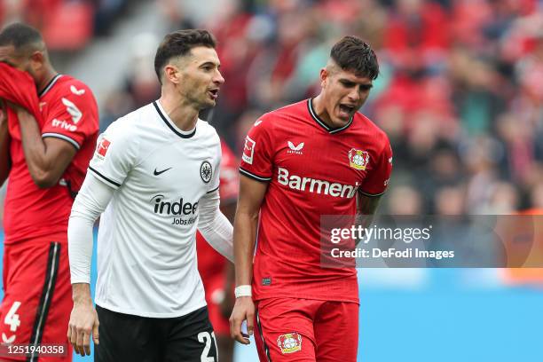 Lucas Alario and Piero Hincapie of Bayer 04 Leverkusen speaks with during the Bundesliga match between Bayer 04 Leverkusen and Eintracht Frankfurt at...