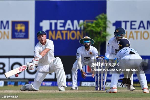 Ireland's Mark Adair plays a shot during the third day of the first cricket Test match between Sri Lanka and Ireland at the Galle International...