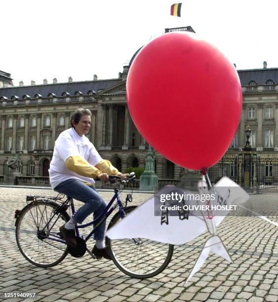 Member of Amnesty International and Human Rights Watch demonstrates with her bike in front of the Brussels Royal Palace during the visit of Chinese...