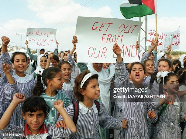 Palestinian schoolgirls demonstrate 18 October 1999 against the Israeli army's intention to confiscate land that will be used for the construction of...