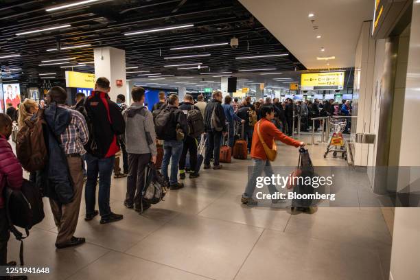 Passengers queue to go through passport control at Schiphol Airport in Amsterdam, Netherlands, on Monday, April 17, 2023. Schiphol Airport, a key...