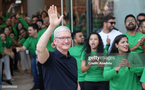 Chief Executive Officer of Apple Tim Cook waves to people during the opening of the first Apple Inc. Flagship store in Mumbai, India on April 18,...