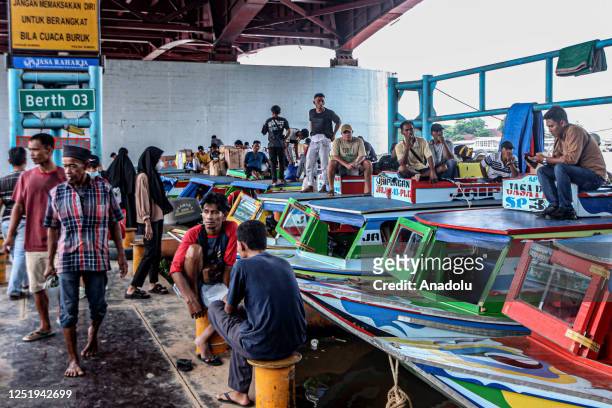 Passengers prepare to depart for their hometowns ahead of the Muslim Eid al-Fitr holiday at 16 Ilir Port in Palembang, Indonesia on April 18, 2023.