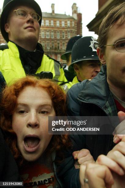 Protestors scuffle with police during an anti-Henry Kissinger demonstration outside the Royal Albert Hall in London, where Kissinger is to address a...
