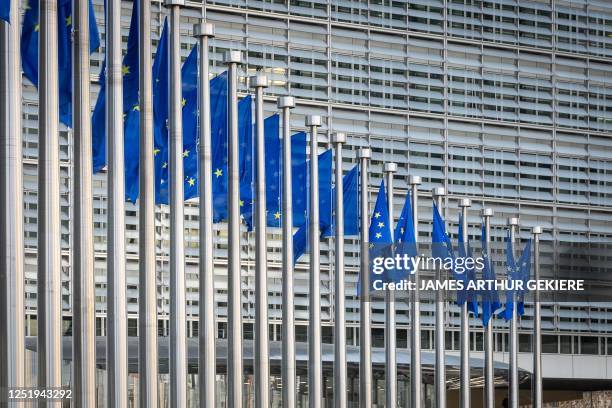 Picture taken in Brussels on April 18, 2023 shows European flags at the Berlaymont building which houses the headquarters of the European Commission,...