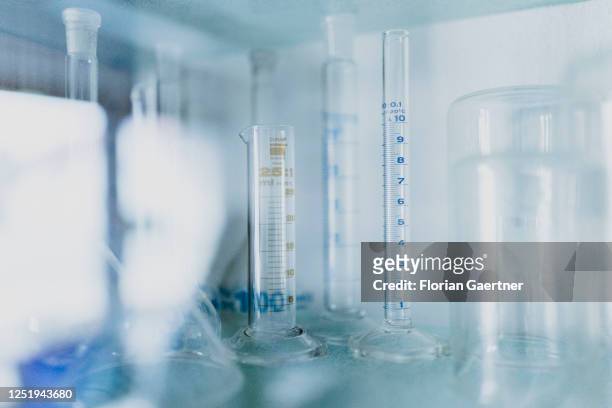 Graduated measuring glasses are pictured in a pharmacy on April 13, 2023 in Niesky, Germany.