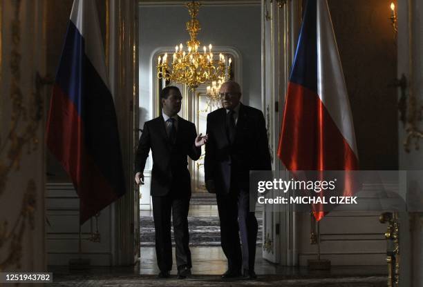 Czech President Vaclav Klaus talks with Russian President Dmitry Medvedev as they walk prior to their meeting on December 8, 2011 at the Prague...